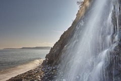 A beachside waterfall at Buck's Mill, near Clovelly, Devon, Great Britain.