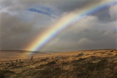 A rainbow above Scorhill Rocks, standing stones on Scorhill Down, nr Chagford, Dartmoor National Park, Devon, Great Britain.