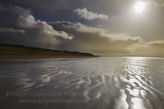 Stormy sunlight on the beach at Berrow, nr Burnham-on-Sea, Somerset, Great Britain.