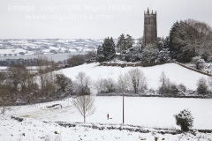 A wintry view of Blagdon Church, with Blagdon Lake in the background, Blagdon, Somerset, Great Britain.