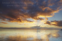 Sunset seen across the beach at Brean, Somerset, Great Britain.
