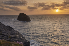Sunset over the Atlantic, with silhouette of Meachard and the cliffs of Boscastle, Cornwall, Great Britain.