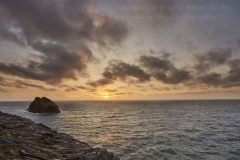 Sunset over the Atlantic, with silhouette of Meachard and the cliffs of Boscastle, Cornwall, Great Britain.
