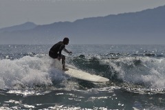 Surfing outside Kapuluan Vista Resort, at Blue Lagoon Beach, Pagudpud, Ilocos Norte, Luzon, Philippines.