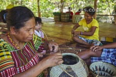 A Mangyan woman weaving a basket, near Talipanan, Puerto Galera, Mindoro, Philippines.