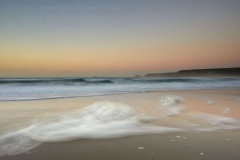 Surf at dusk; Sennen Cove, Cornwall, Great Britain.
