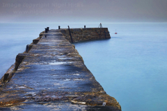 The breakwater at Sennen Cove at dawn; near Land's End, Cornwall, Great Britain.