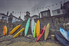 Kayaks in the fishing harbour at Mousehole, near Penzance, Cornwall, Great Britain.