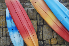Kayaks in the fishing harbour at Mousehole, near Penzance, Cornwall, Great Britain.